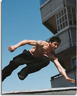 David Belle jumping from rooftop to rooftop